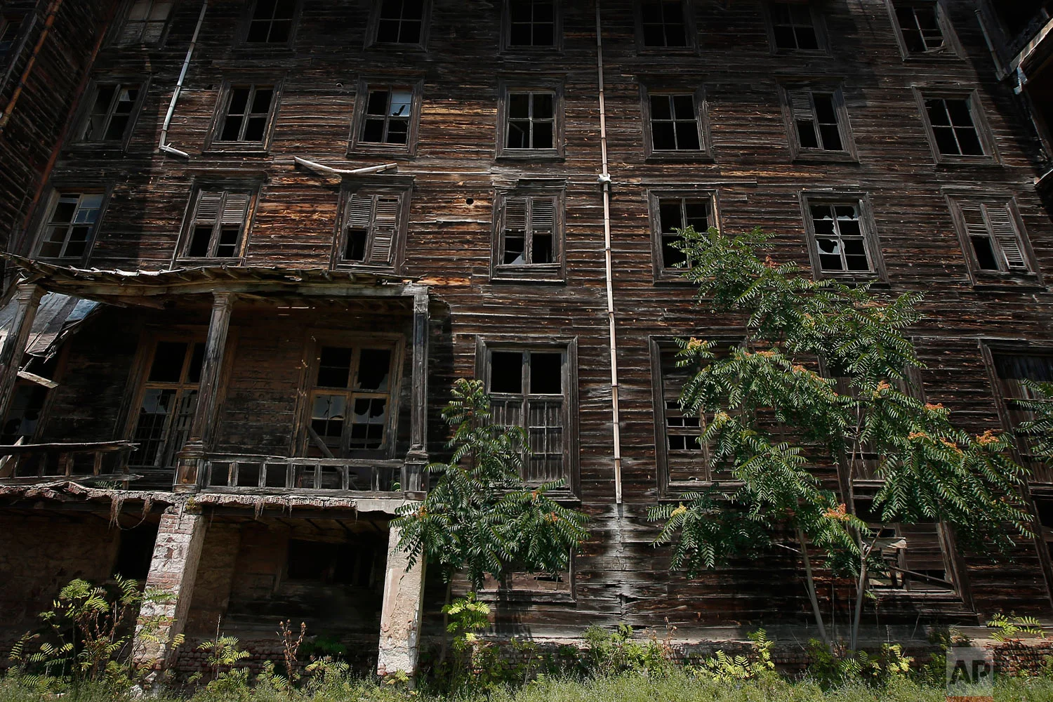 This July 21, 2018, photo, shows an exterior view of the 6-floor timber building that once served as an orphanage for children of the minority Greek community, in Buyukada, the largest and most popular of the Princes' Islands in the Sea of Marmara near Istanbul. (AP Photo/Lefteris Pitarakis)