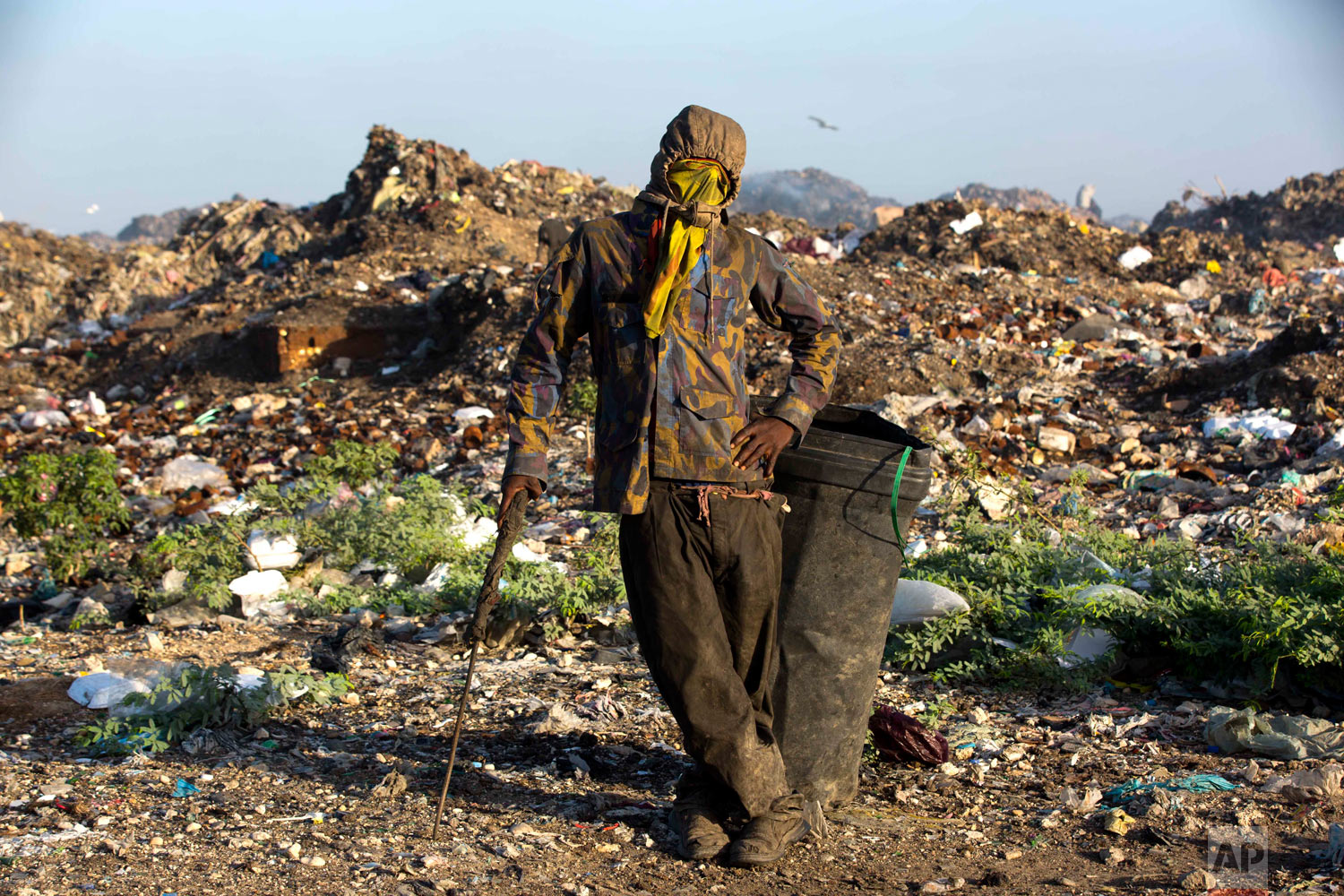  Changlair Aristide pauses for a portrait wearing an old U.N. peacekeeper's jacket he found in the trash. Aug. 24, 2018. (AP Photo/Dieu Nalio Chery) 