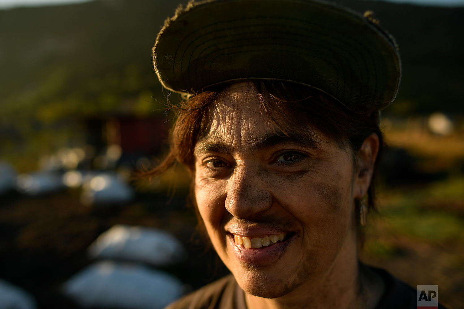  In this Tuesday, Sept.11, 2018 photo, Mertxe García, poses for a photograph as she works producing traditional charcoal in Viloria, northern Spain. (AP Photo/Alvaro Barrientos) 