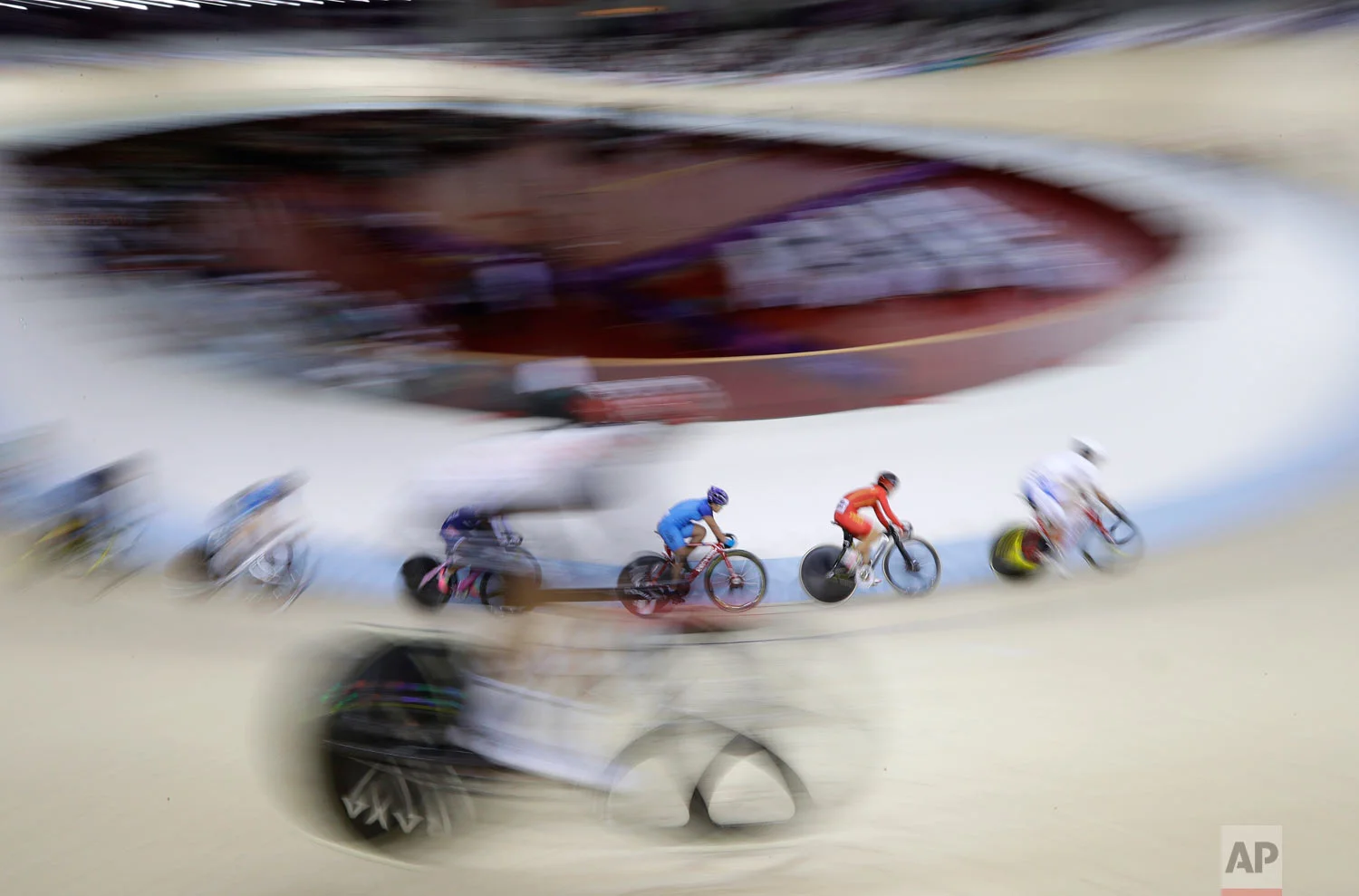 Riders compete in the women's omnium gold medal race during the track cycling at the 18th Asian Games in Jakarta, Indonesia, Wednesday, Aug. 29, 2018. (AP Photo/Aaron Favila)