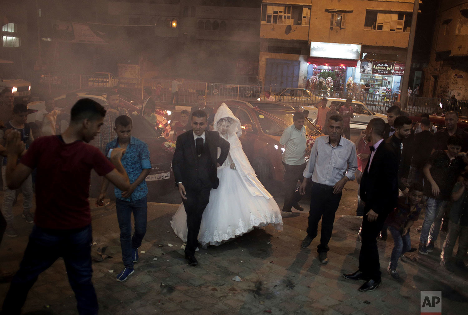  In this July 31, 2016 photo, Palestinian groom Saed Abu Aser, and his bride, Falasteen, walk into the wedding hall, in Gaza City. (AP Photo/Khalil Hamra) 