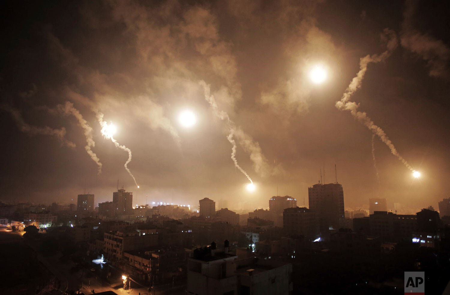  In this July 29, 2014 photo, Israeli forces' flares light up the night sky of Gaza City. (AP Photo/Khalil Hamra) 