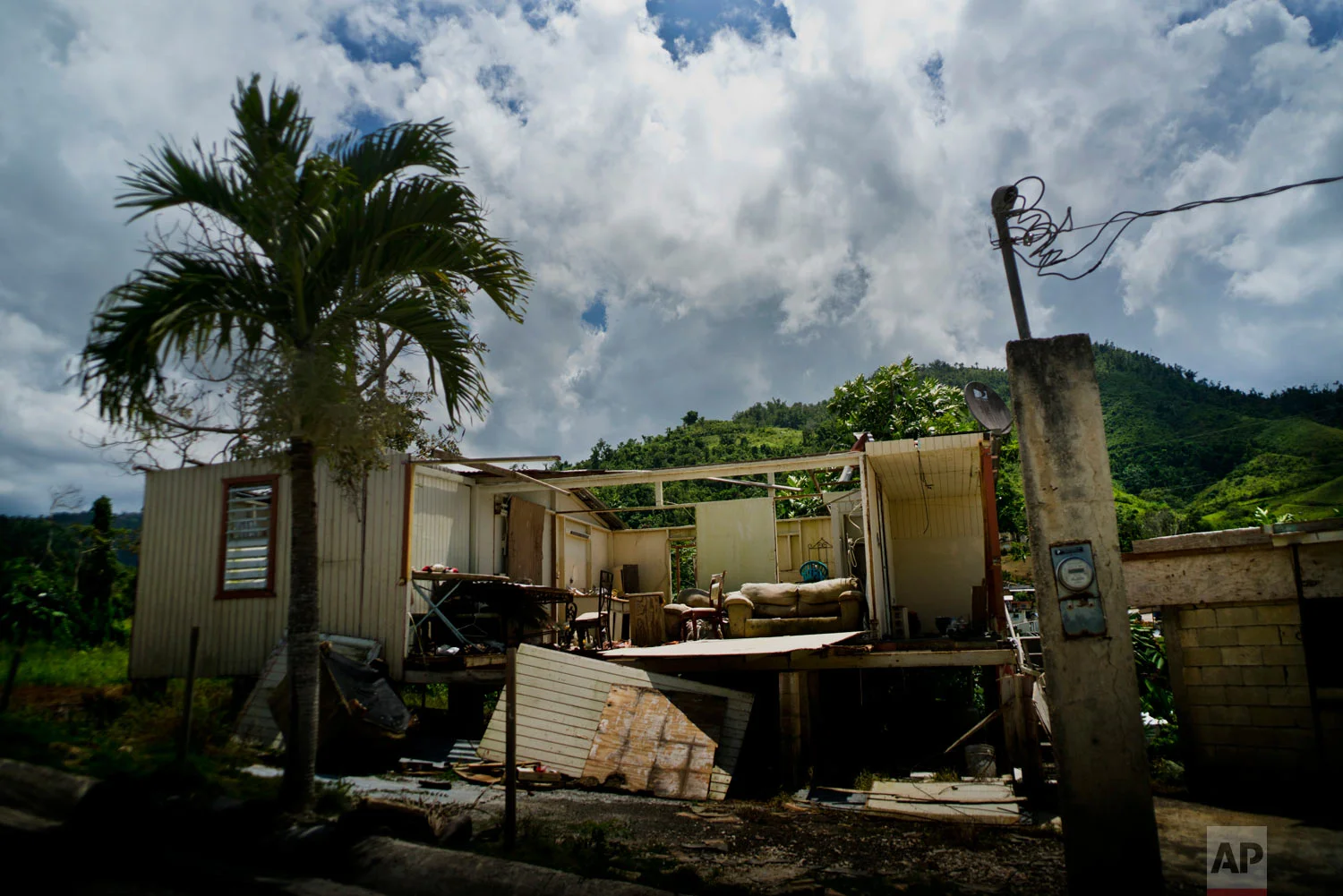  In this Sept. 8, 2018 photo, a home abandoned after Hurricane Maria hit one year ago stands full of furniture in the San Lorenzo neighborhood of Morovis, Puerto Rico. (AP Photo/Ramon Espinosa) 