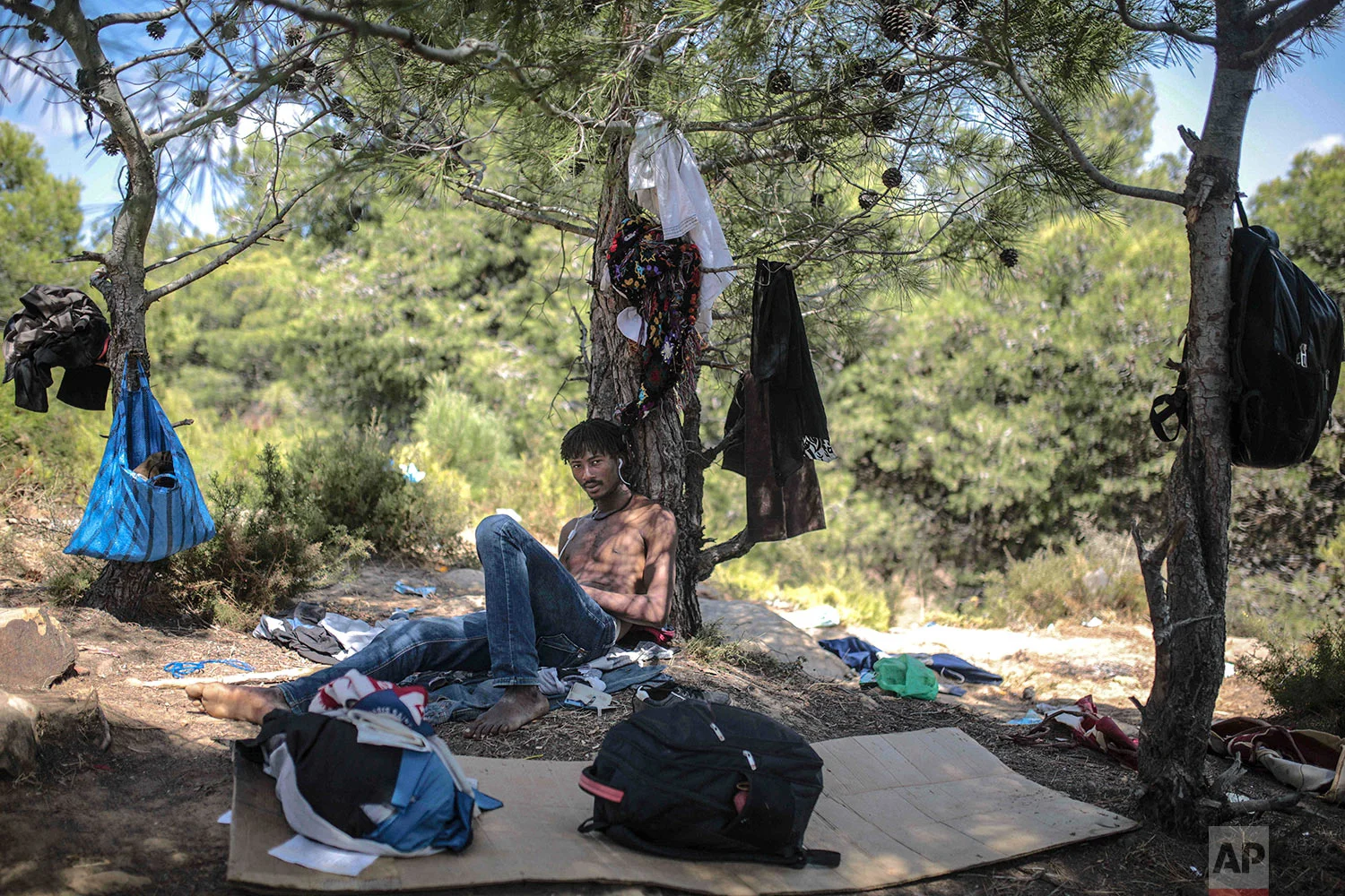 Tresor-Debrun, a Cameroonian migrant, poses for a portrait as he takes shelter in a forest near Masnana, Sept. 5, 2018, on the outskirts of Tangier, Morocco. (AP Photo/Mosa'ab Elshamy)
