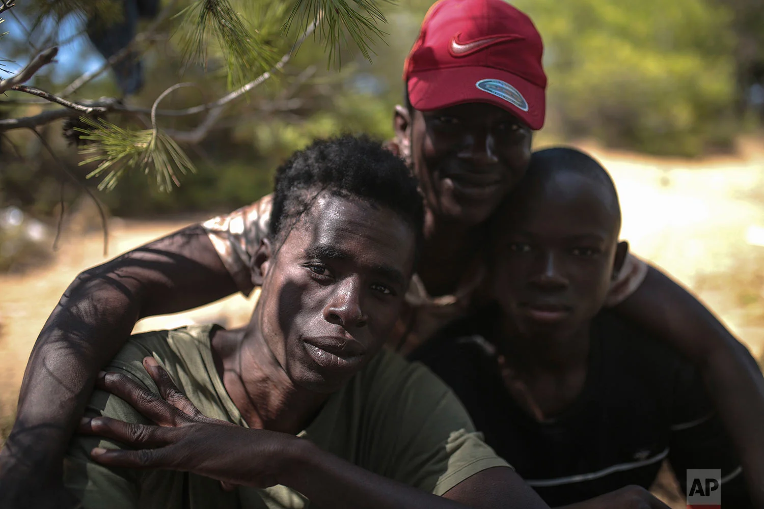 Sub-Saharan migrants pose for a portrait as they take shelter in a forest near Masnana, Sept. 5, 2018, on the outskirts of Tangier, Morocco. (AP Photo/Mosa'ab Elshamy)