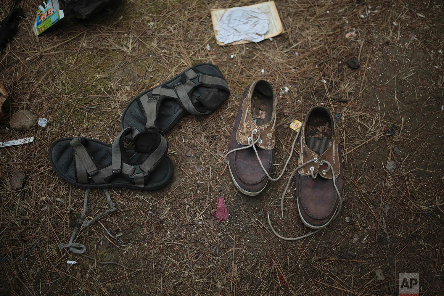 Shoes belonging to sub-Saharan migrants aiming to cross to Europe are scattered on in a forest following a police raid, Sept. 8, 2018, near Masnana, on the outskirts of Tangier, Morocco. (AP Photo/Mosa'ab Elshamy)