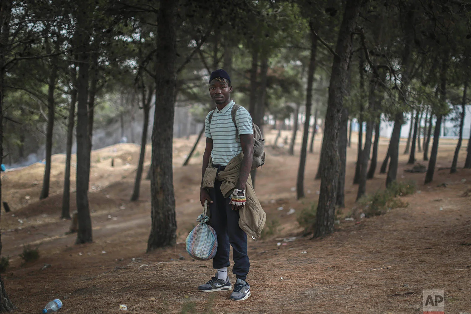 Alex Brandan, a Cameroonian migrant, poses for a portrait as he takes shelter in a forest near Masnana, Sept. 8, 2018, on the outskirts of Tangier, Morocco. (AP Photo/Mosa'ab Elshamy)