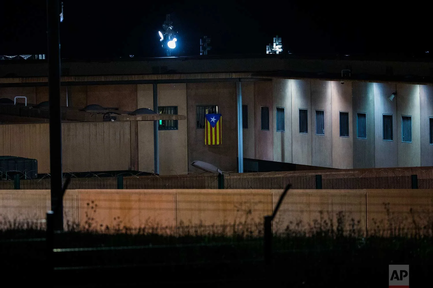 In this Tuesday, Sept. 18, 2018 photo, an "estelada" or independence flag, is waved from the window of a cell in Lledoners prison, in Sant Joan de Vilatorrada, about 50 kilometres away from Barcelona, Spain. (AP Photo/Emilio Morenatti)