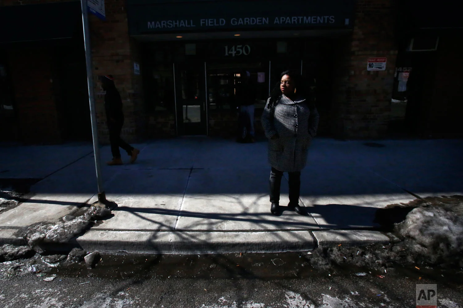 In this March 5, 2015, photo, Precious Murphy stands outside Marshall Field Garden Apartments, one of the last larger-scale buildings with subsidized housing in a neighborhood that was once home to Chicago's Cabrini-Green housing project, in Chicago. Despite her interest in Art on Sedgwick and friendship with its founder, Charlie Branda, Murphy and her four children moved to Bloomington, Indiana, to start a new life. (AP Photo/Martha Irvine)