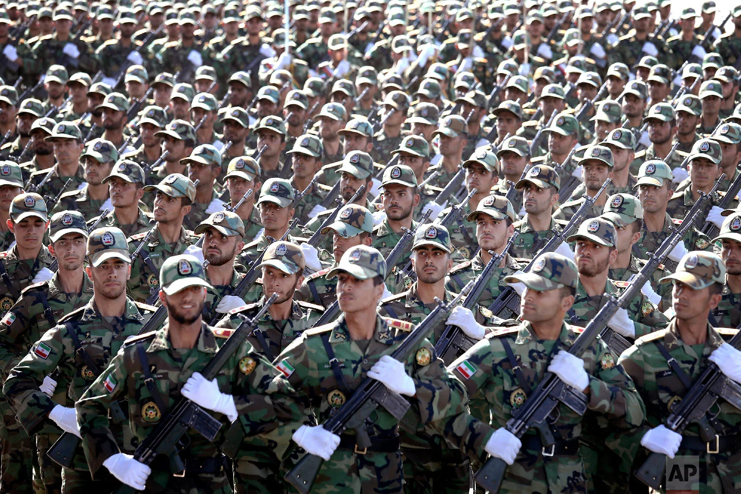 Iranian armed forces members march in a military parade marking the 38th anniversary of Iraq's 1980 invasion of Iran, in front of the shrine of the late revolutionary founder, Ayatollah Khomeini, just outside Tehran, Iran, Sept. 22, 2018. (AP Photo/Ebrahim Noroozi)