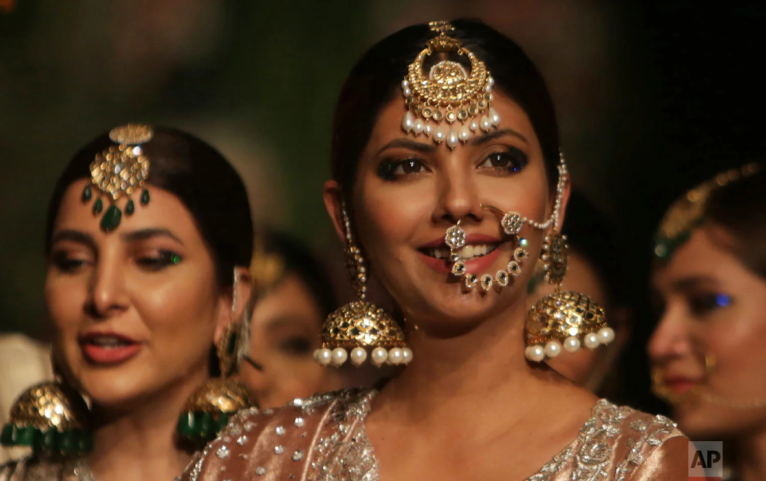 Models present traditional jewelry designed by Nida Azwer during a fashion show by the Loreal Paris Pakistan Fashion Design Council in Lahore, Pakistan, Sept. 5, 2018. (AP Photo/K.M. Chaudary)