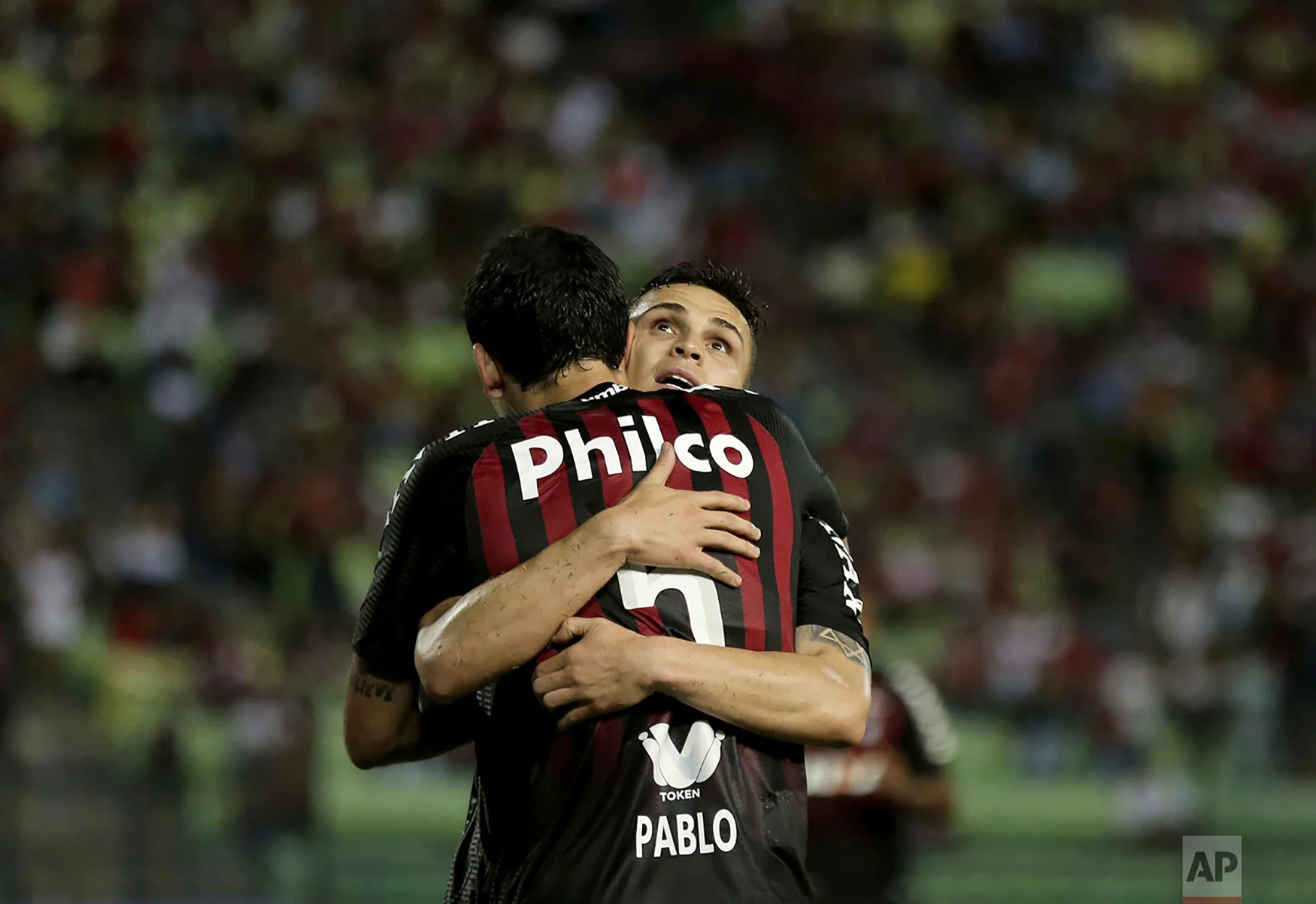 Raphael Veiga of Brazil's Atletico Paranaense celebrates with his teammate Pablo, after scoring his second goal against Venezuela's Caracas FC during their Copa Sudamericana soccer match in Caracas, Venezuela, Sept. 19, 2018.(AP Photo/Fernando Llano)
