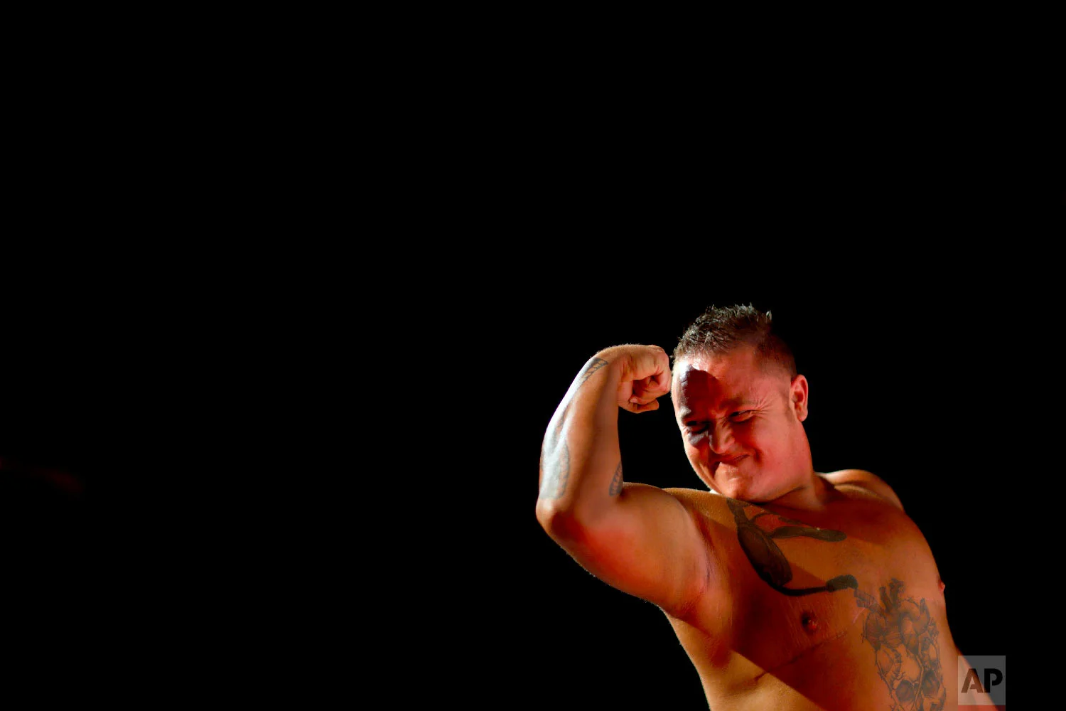 Kennedy Conners, of Conyers, Ga., flexes for the judges during the International Association of Trans Bodybuilders competition in Atlanta, Oct. 6, 2018. Conners transitioned from female a year and half ago. (AP Photo/David Goldman)