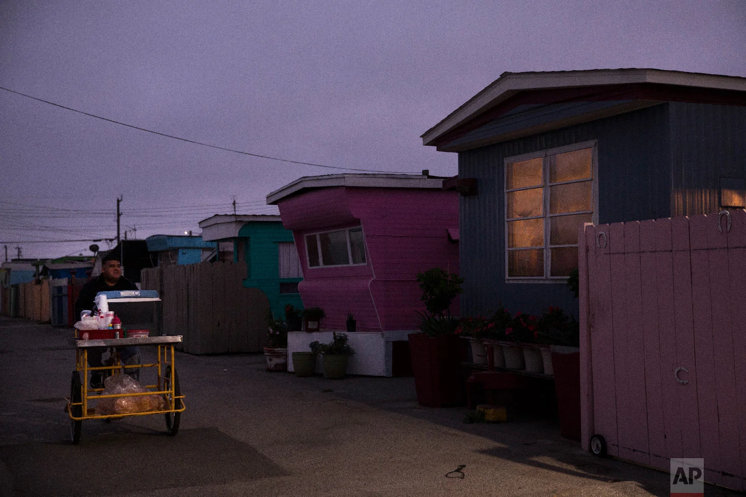 A food vendor passes through a mobile home park, where majority of tenants are farm workers, in Salinas, Calif., on Sept. 3, 2018. (AP Photo/Jae C. Hong)