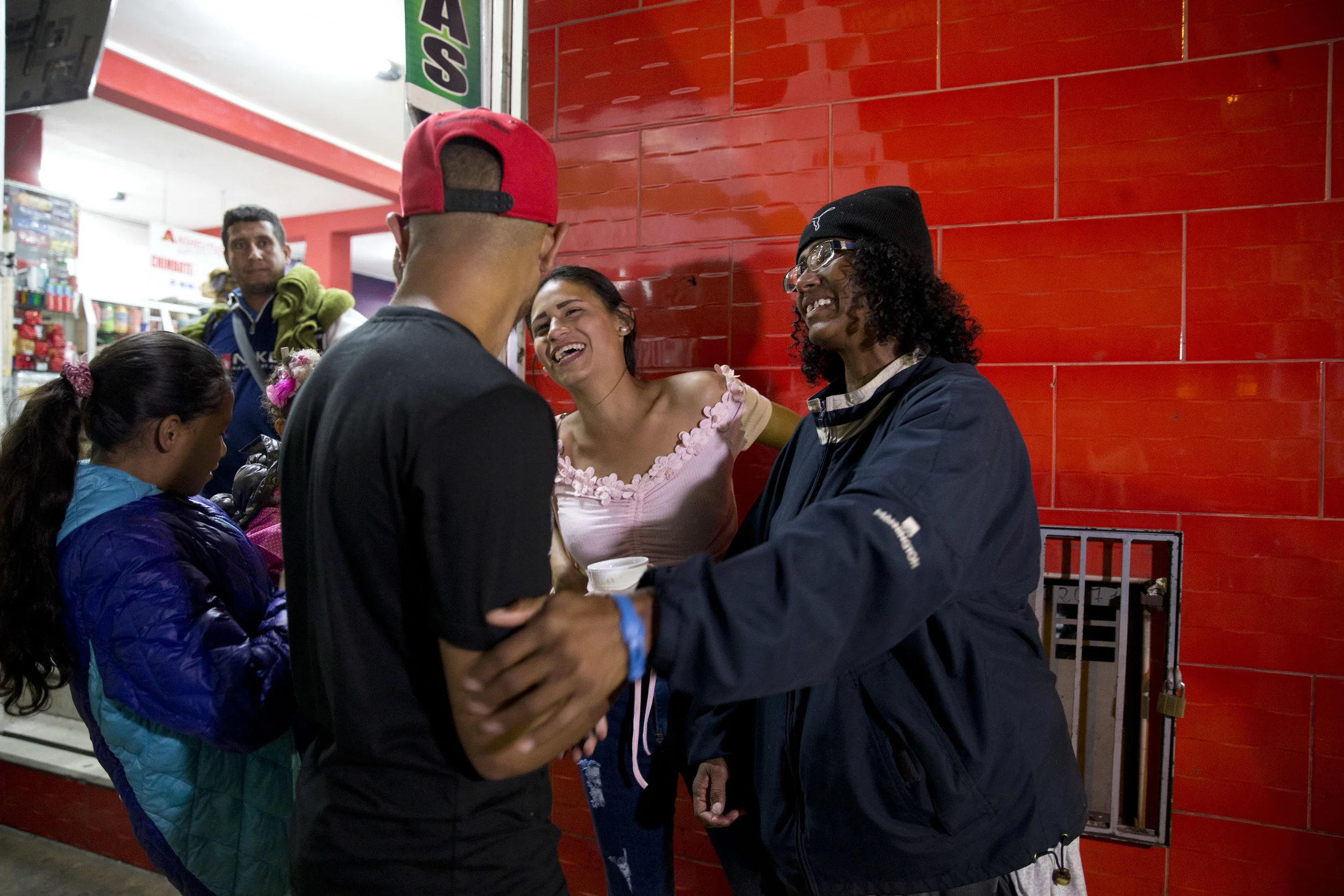 Sandra Cadiz and her daughter reunite with Cadiz’s son Leonardo and her daughter-in-law on Sept. 8, 2018. (AP Photo/Ariana Cubillos)