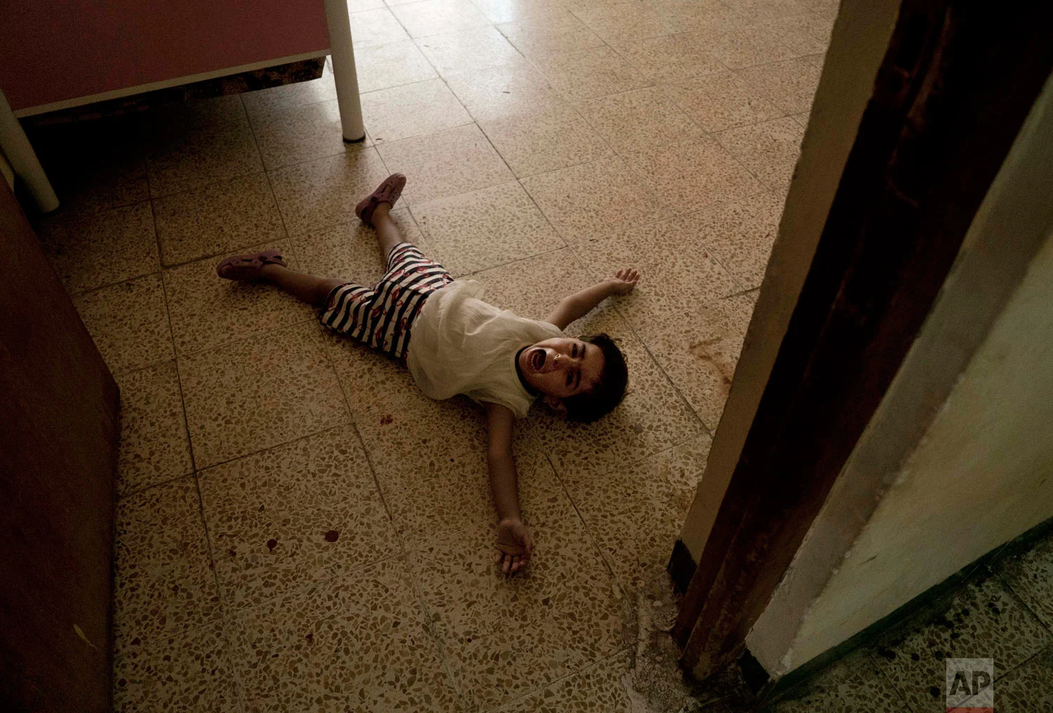 A girl has a tantrum at the state-run al-Zuhour Orphanage in Mosul, Iraq. (AP Photo/Maya Alleruzzo)