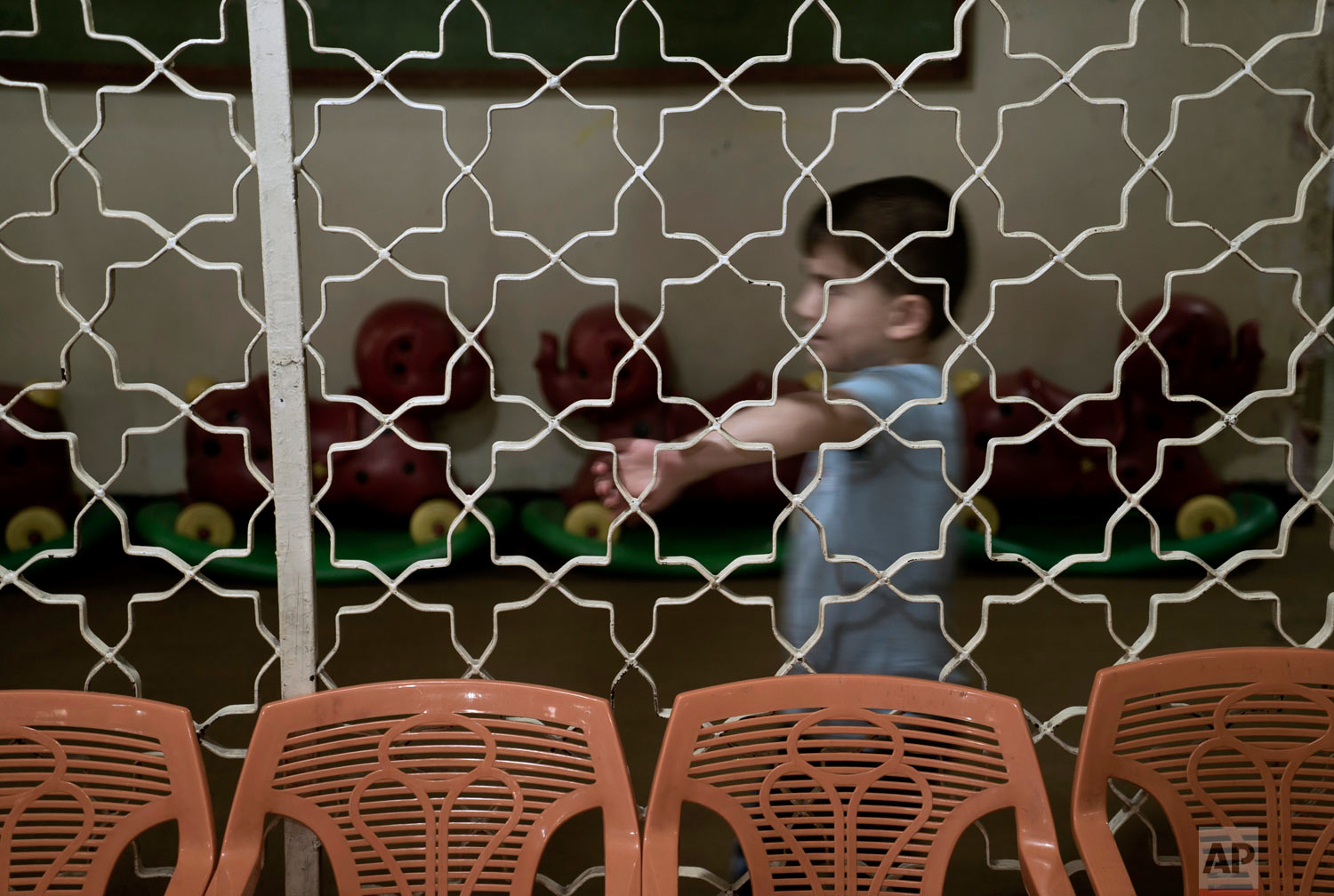  A boy plays in the hallway at the state-run Salhiya Orphanage in Baghdad, Iraq. "We have slowly changed their ideas and the way they think," said Abeer al-Chalabi, a senior government official in charge of social affairs in Baghdad. (AP Photo/Maya A