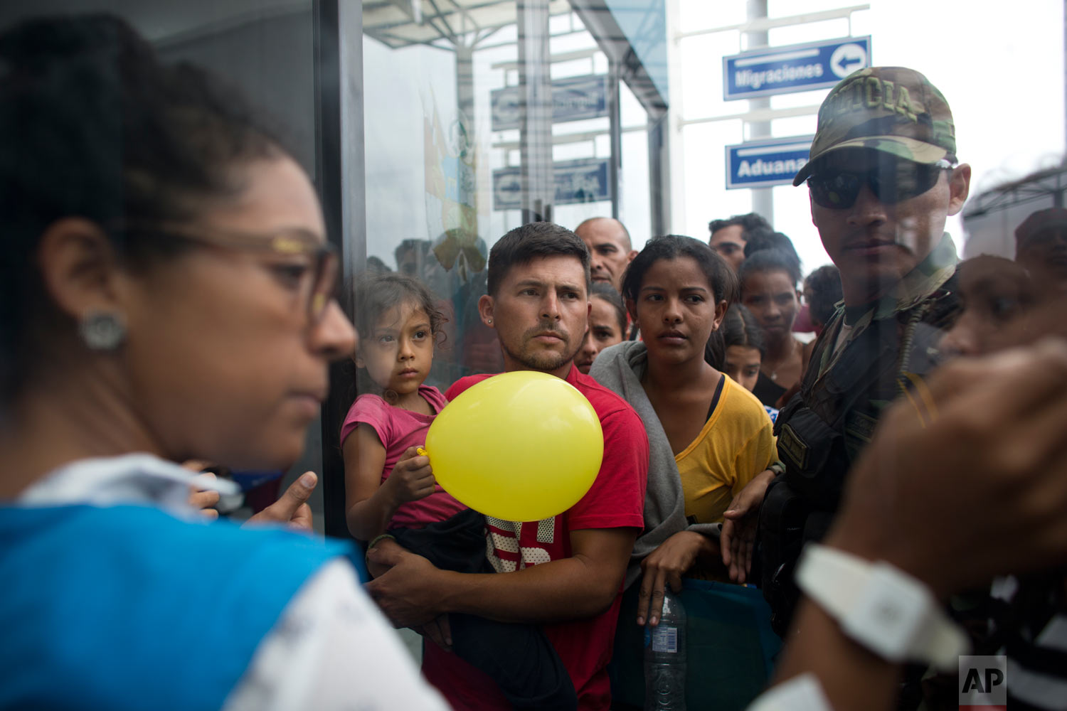  In this Sept. 6, 2018 photo, Venezuelans wait in line to be attended by Peruvian immigration officials in hopes of entering the country, in Tumbes, Peru. Many Venezuelans' final destination is Lima, Peru, a city where most believe they will have mor