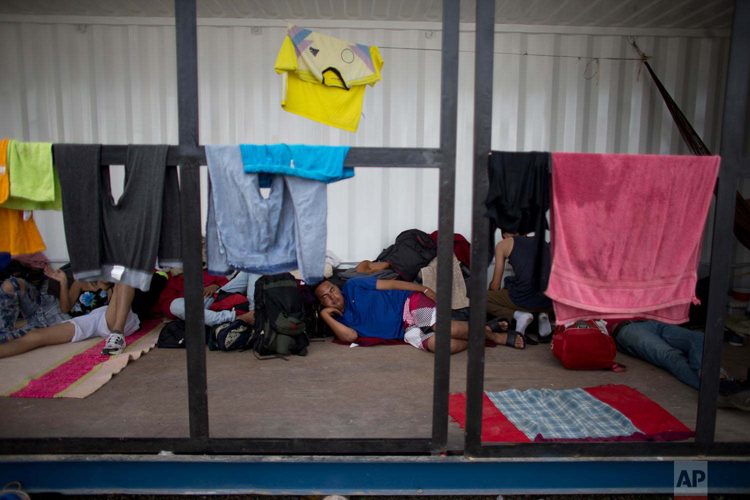  In this Sept. 7, 2018 photo, Venezuelans rest as they wait in a shipping container near Peru's immigration office in Aguas Verdes, Peru. Venezuelan migrants who can't afford a bus or plane flee by foot, risking their lives as they try to cross throu