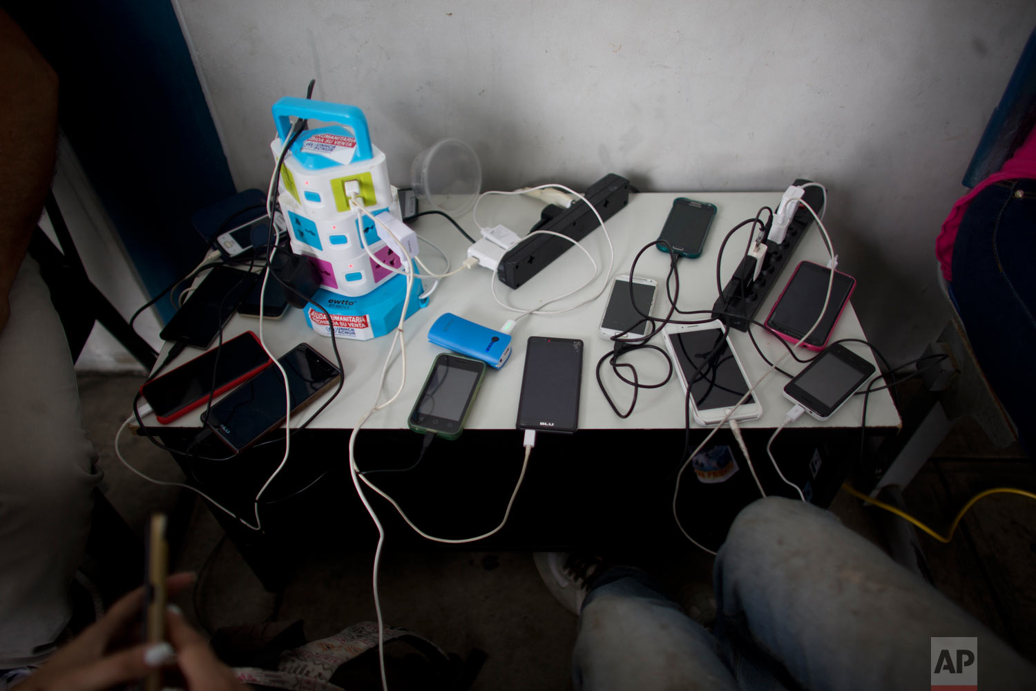  In this photo Sept. 7, 2018 photo, cellphones belonging to Venezuelans are charged for free at the immigration office in Aguas Verdes, Peru. It’s not known how many reach their final destination. Facebook groups are filled with posts from Venezuelan