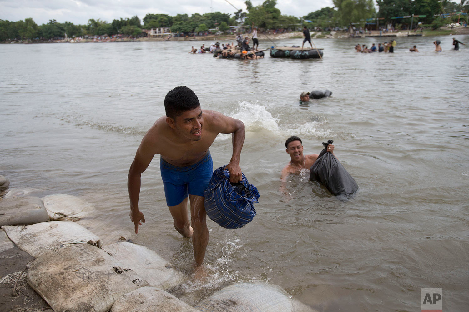  Central American migrants reach the shore on the Mexican side of the Suchiate River after wading across, on the the border between Guatemala and Mexico, in Ciudad Hidalgo, Mexico, Saturday, Oct. 20, 2018. (AP Photo/Moises Castillo) 