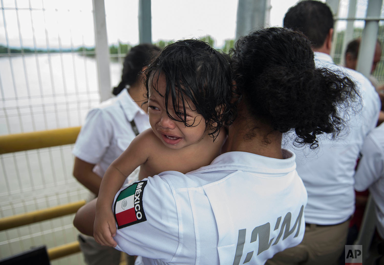  A Honduran migrant child held by a Mexican immigration worker, cries after crossing the border between Guatemala and Honduras with his family, in Ciudad Hidalgo, Mexico, Saturday, Oct. 20, 2018. (AP Photo/Oliver de Ros) 