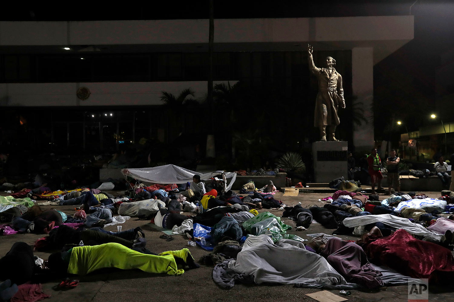  Honduran migrants hoping to reach the U.S. sleep in the southern Mexico city of Tapachula, Monday, Oct. 22, 2018, in a public plaza featuring a statue of Mexican national hero Miguel Hidalgo, a priest who launched Mexico's War of Independence in 181