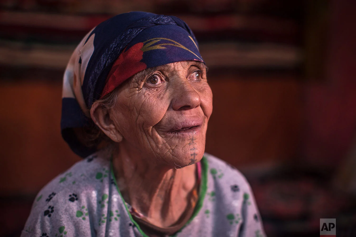 In this Saturday, Oct. 13, 2018 photo, Hadda Oaabjde, 71, poses for a portrait displaying her face tattoo, in the Middle Atlas town of Tinguerf, near Azilal, central Morocco. (AP Photo/Mosa'ab Elshamy)
