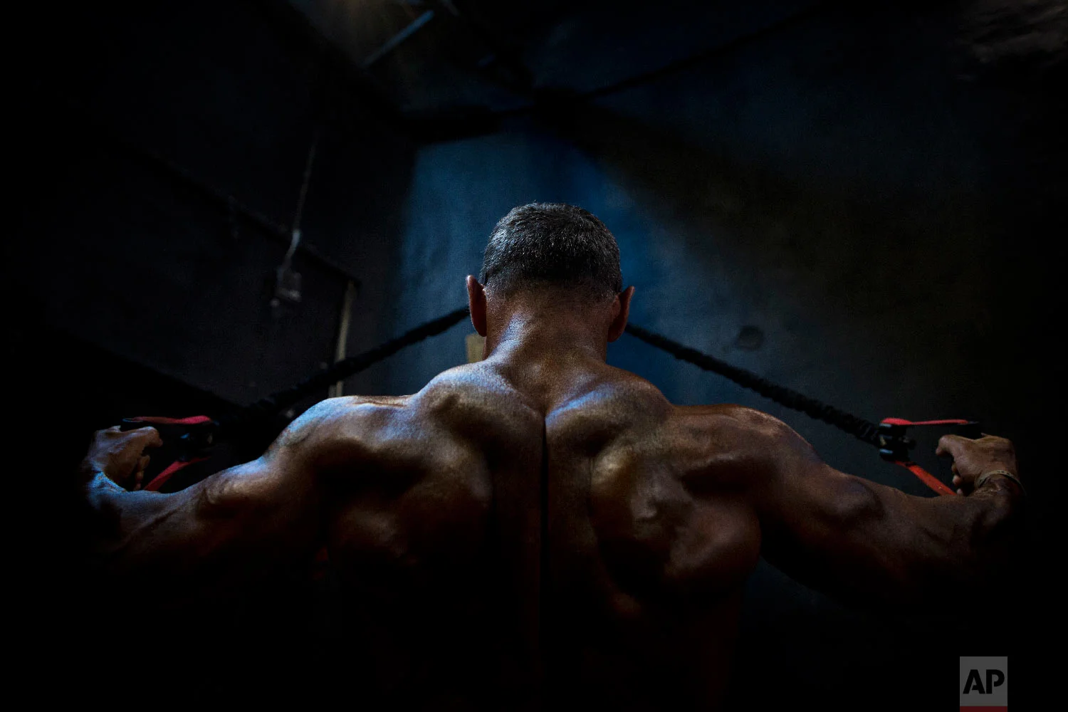 A contestant exercises backstage during the National Amateur Body Builders' Association competition in Tel Aviv, Israel on Oct. 18, 2018. (AP Photo/Oded Balilty)