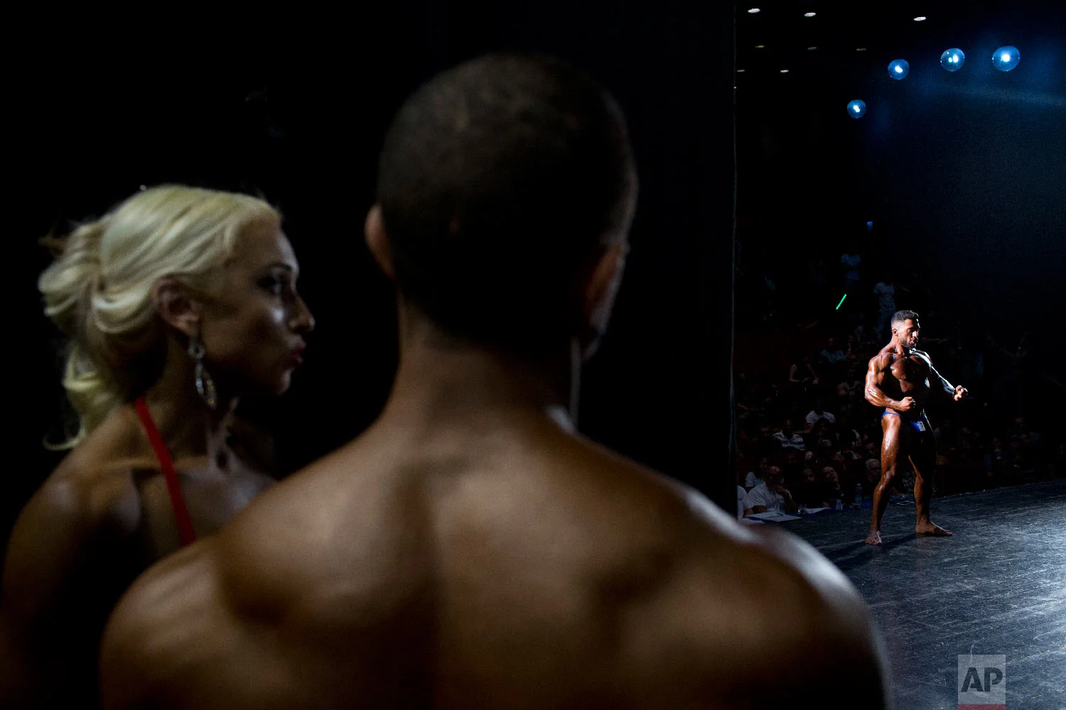 A contestant flexes for the judges during the National Amateur Body Builders' Association competition in Tel Aviv, Israel on Oct. 18, 2018. (AP Photo/Oded Balilty)