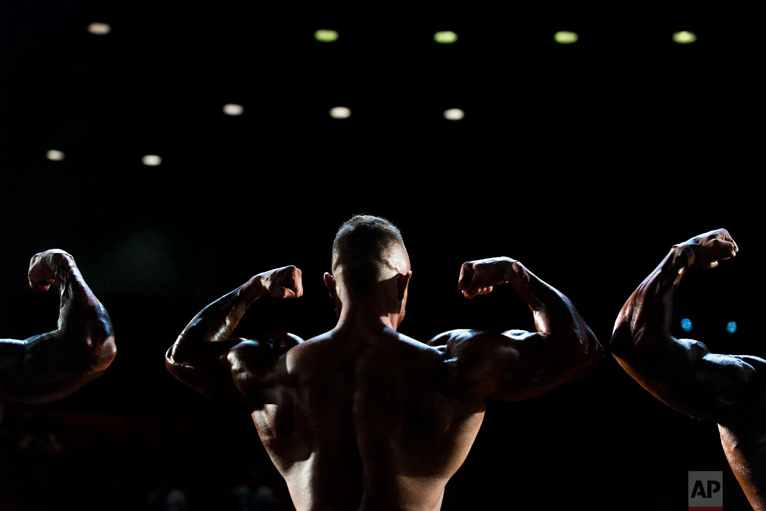 Contestants participate in the final round during the National Amateur Body Builders' Association competition in Tel Aviv, Israel on Oct. 18, 2018. (AP Photo/Oded Balilty)
