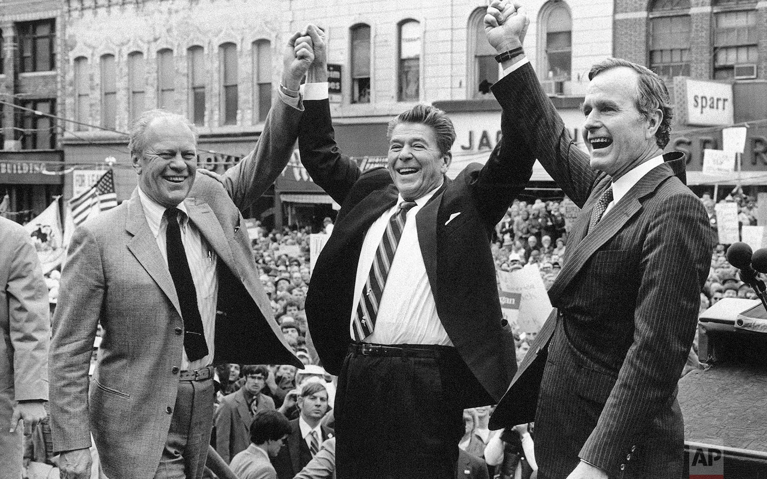 Former President Gerald Ford lends his support to Republican presidential candidate Ronald Reagan and his running mate George H.W. Bush, on Nov. 3, 1980, in Peoria, Ill. (AP Photo)