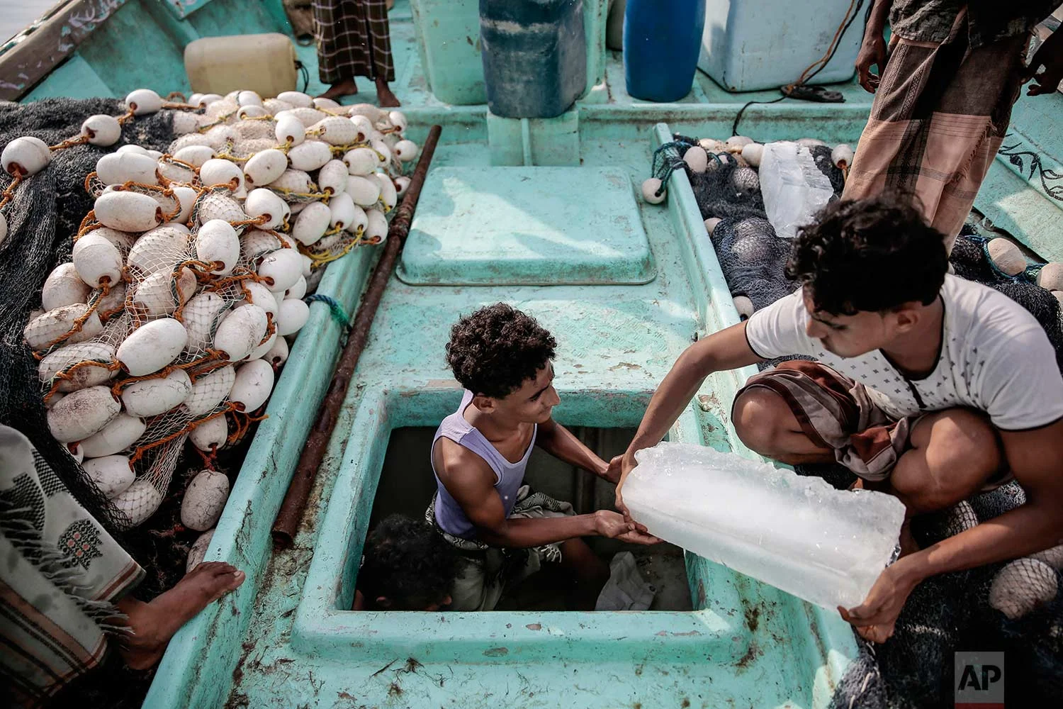 In this Sept. 29, 2018, photo, Yemeni fishermen work on their boat at the main fishing port, in Hodeida, Yemen. (AP Photo/Hani Mohammed)