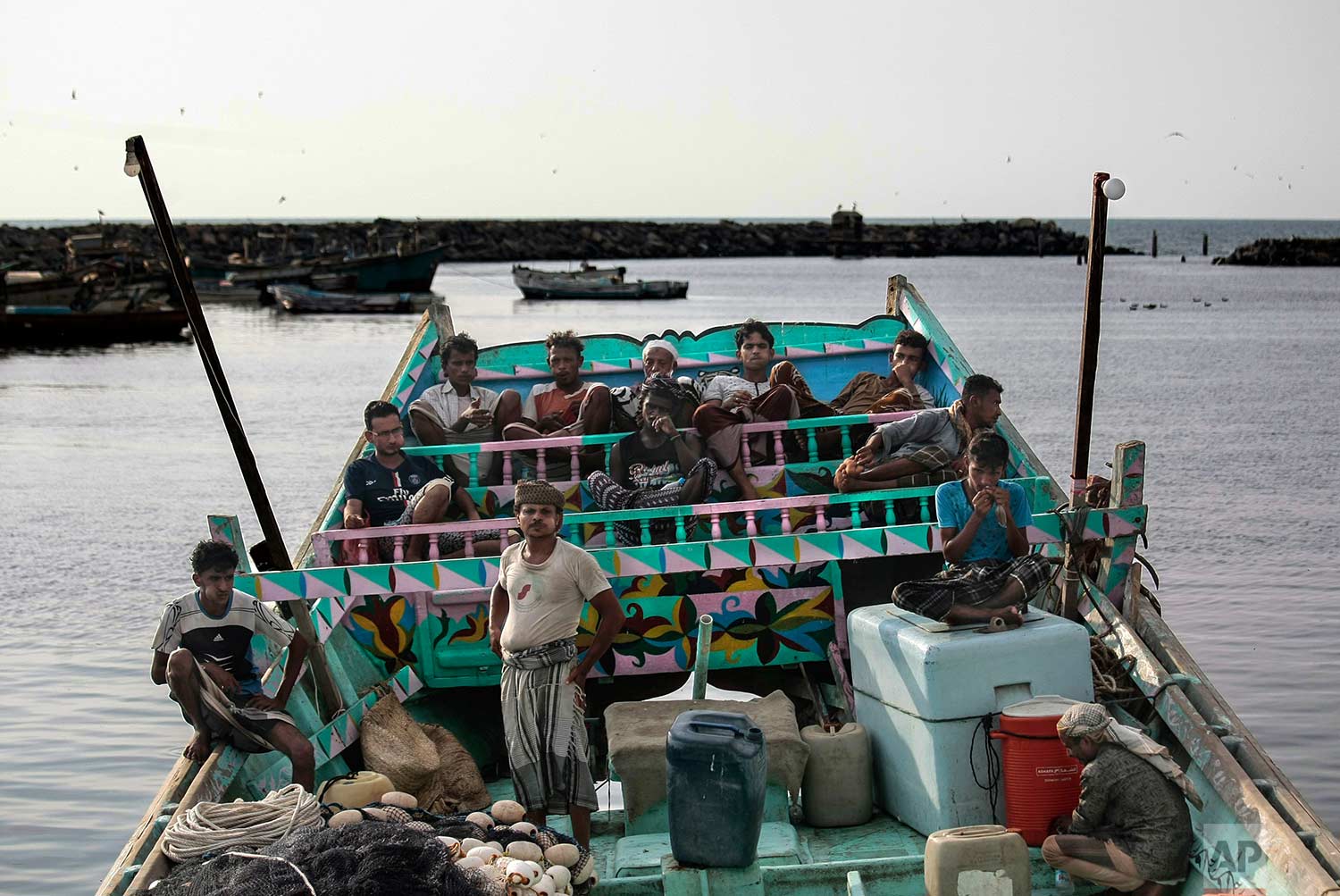 In this Sept. 29, 2018, photo, fishermen take a break and chew Qat, an amphetamine-like stimulant, on a boat at the main fishing port, in Hodeida, Yemen. (AP Photo/Hani Mohammed)