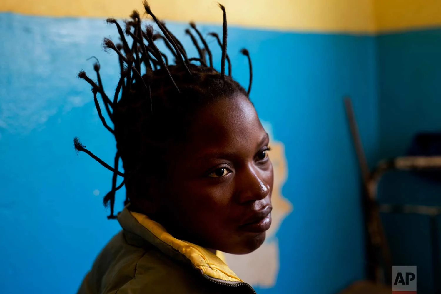 Kimenua Ngoie, 22, sits on her hospital bed at the Katuba Reference Hospital in Lubumbashi, Democratic Republic of the Congo on Monday, Aug. 13, 2018. Ngoie, who lost her baby at birth following a C-section, has been effectively imprisoned by the hospital for the past there month, unable to pay the $360 costs of her operation. (AP Photo/Jerome Delay)