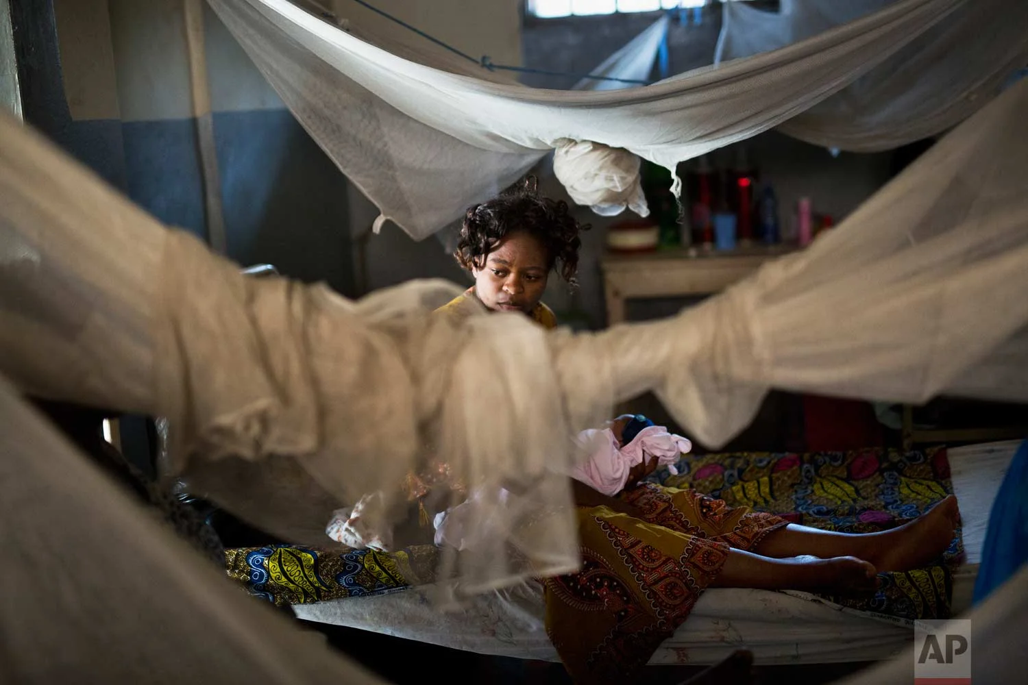 Karena Anny, 30, holds her baby at the Masaidiano Health Center in Lubumbashi, Democratic Republic of the Congo on Tuesday, Aug. 14, 2018. Anny has been detained at the hospital for a month, unable to pay the $400 cost of her cesarian delivery. (AP Photo/Jerome Delay)