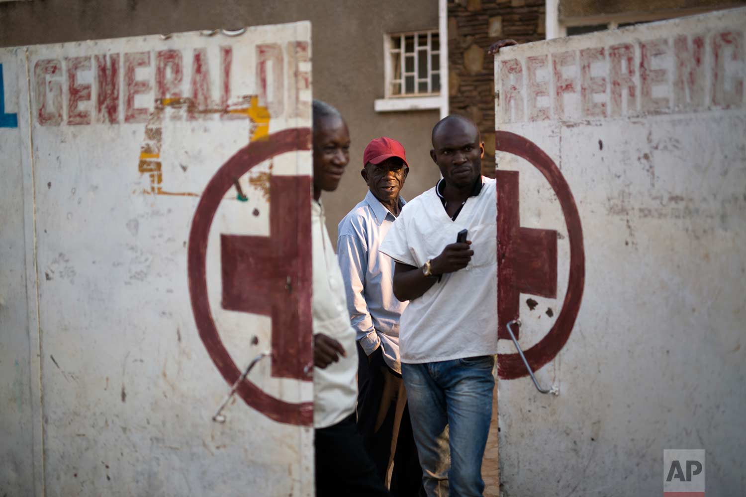  Employees guard the door of the Katuba Reference Hospital in Lubumbashi, Democratic Republic of the Congo on Monday, Aug. 13, 2018. (AP Photo/Jerome Delay) 