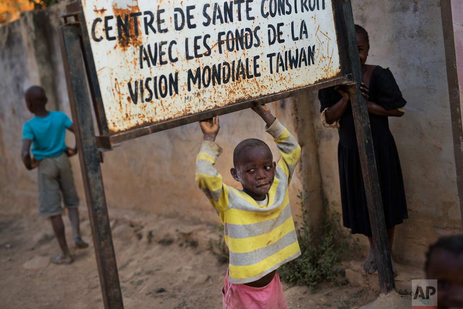  A child plays under a sign reading, "health center built with funding from Taiwan World Vision Funds" at the Mama Wa Mapendo clinic in Lubumbashi, Democratic Republic of the Congo on Tuesday, Aug. 14, 2018. (AP Photo/Jerome Delay) 