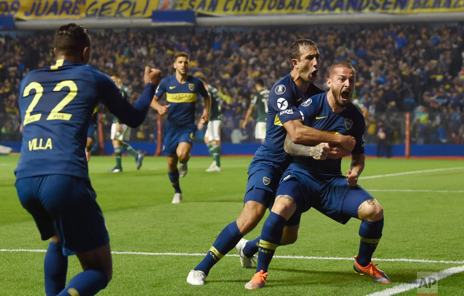 Dario Benedetto of Argentina's Boca Juniors, right, celebrates his first of two goals against Brazil's Palmeiras during a Copa Libertadores semifinal first leg soccer match in Buenos Aires, Argentina, Wednesday, Oct. 24, 2018. Boca won 2-0. (AP Photo/Gustavo Garello)