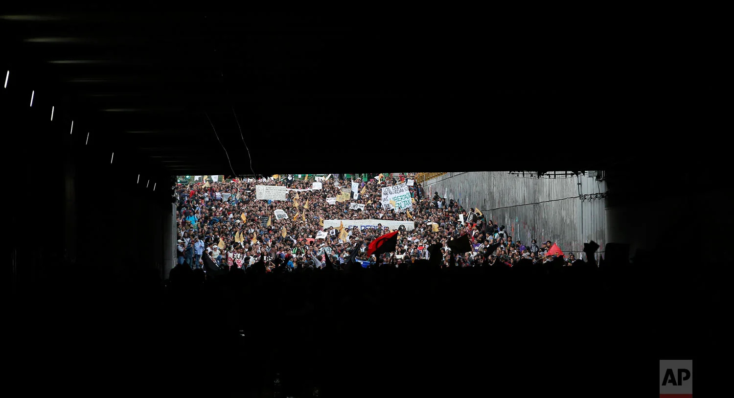 Demonstrators march in remembrance of the 1968 Tlatelolco student massacre in Mexico City, Oct. 2, 2018. Mexico marked the massacre of student protesters by army troops 50 years ago. (AP Photo/Eduardo Verdugo)