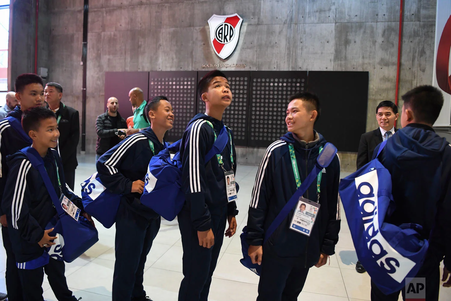 Members of the Thai team Wild Boars tour River Plate's Monumental stadium on the sidelines of the Youth Olympic Summer Games in Buenos Aires, Argentina, Oct. 7, 2018. The team made up of 12 boys and their coach, who were rescued from a cave in Thailand, played a friendly match against the youth team of River Plate. (Eitan Abramovich/Pool via AP)
