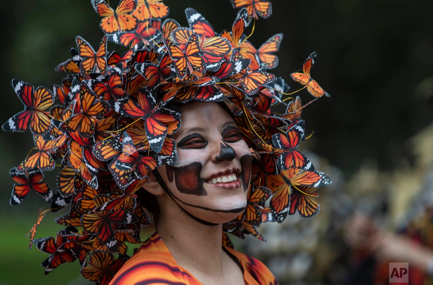 A performer wearing a Monarch butterfly costume attends the Day of the Dead parade in Mexico City Oct. 27, 2018. (AP Photo/Christian Palma)