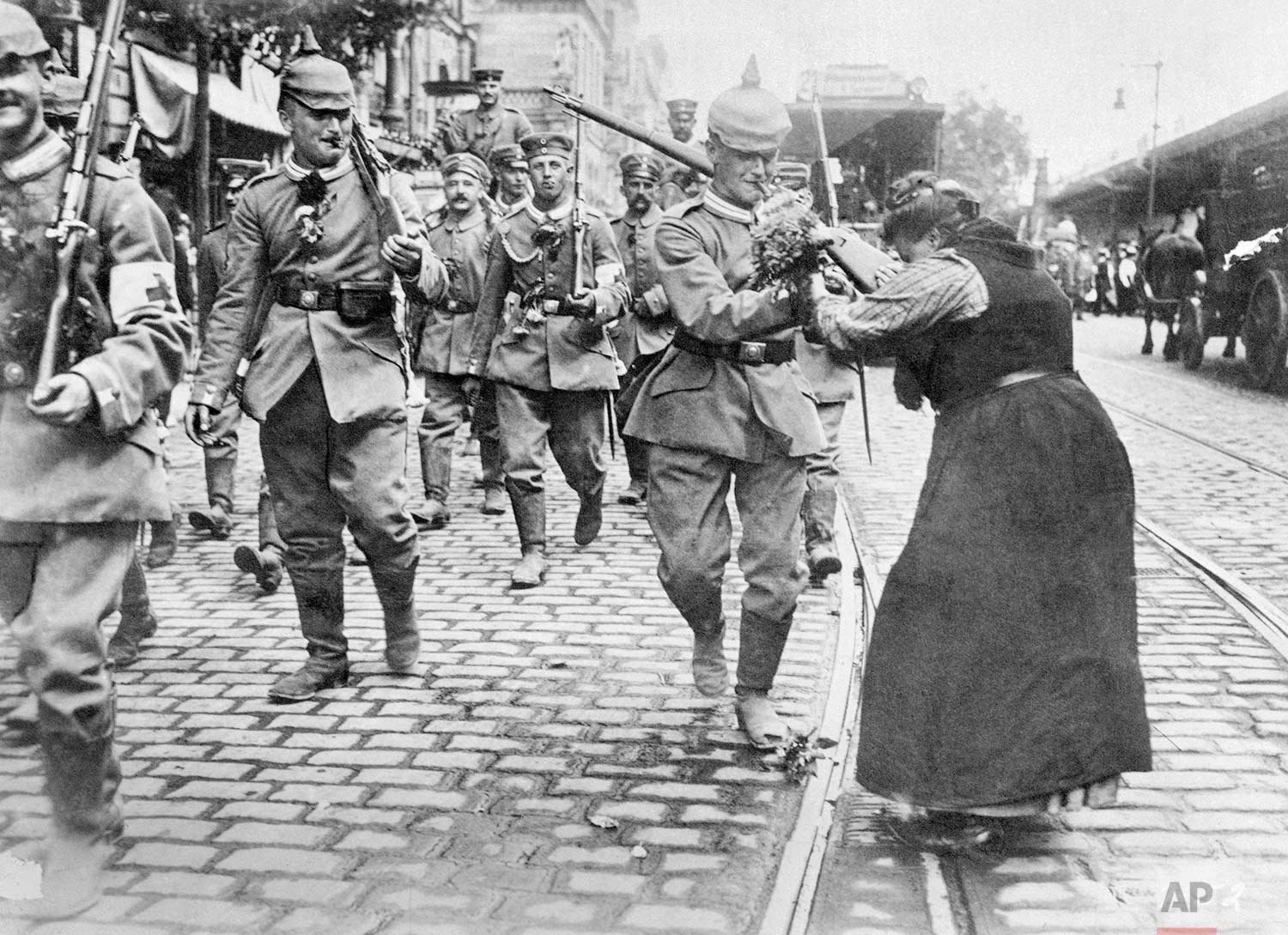  In this undated photo, Prussian soldiers leaving Berlin for the front are given flowers by a woman during World War One. (AP Photo)
 