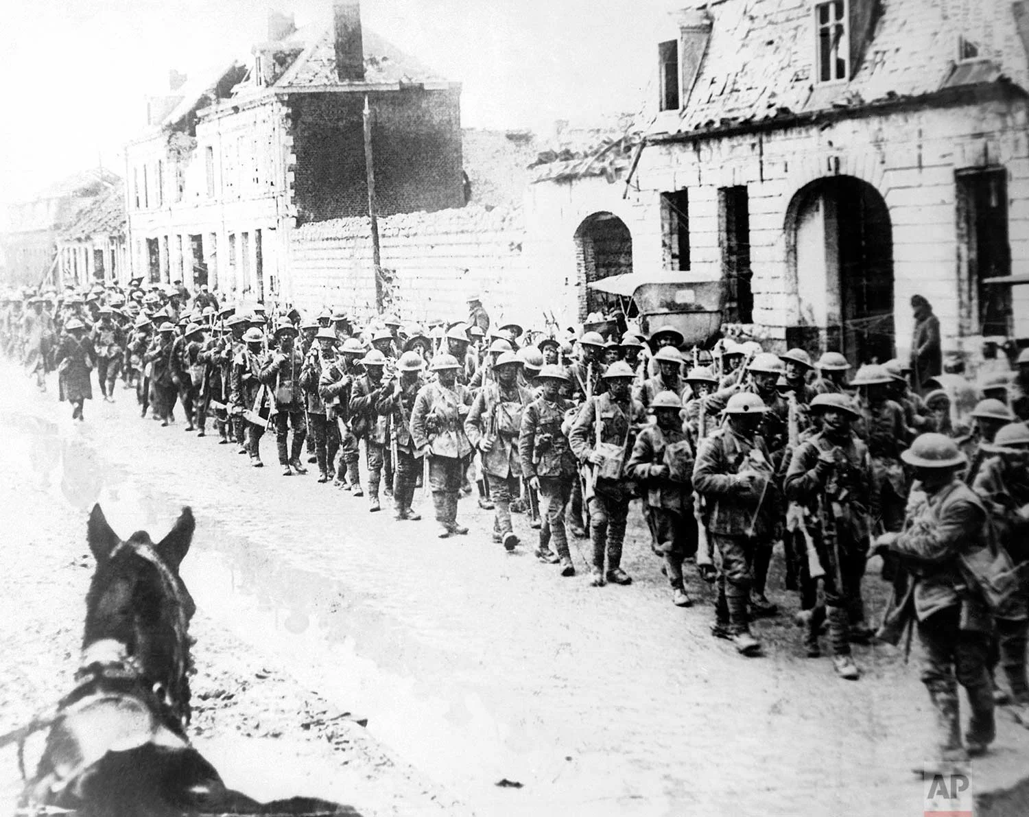 In this 1917 photo, British World War One soldiers return in formation to Ypres, Belgium. (AP Photo)