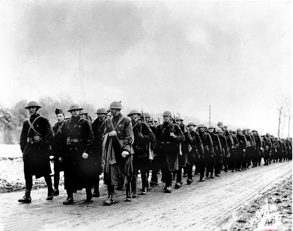  In this March 1918 photo, American soldiers of Company K, 165th Infantry of the Fighting 69th, Old Rainbow Division, march to the trenches at St. Clement, France during World War One. (AP Photo) 