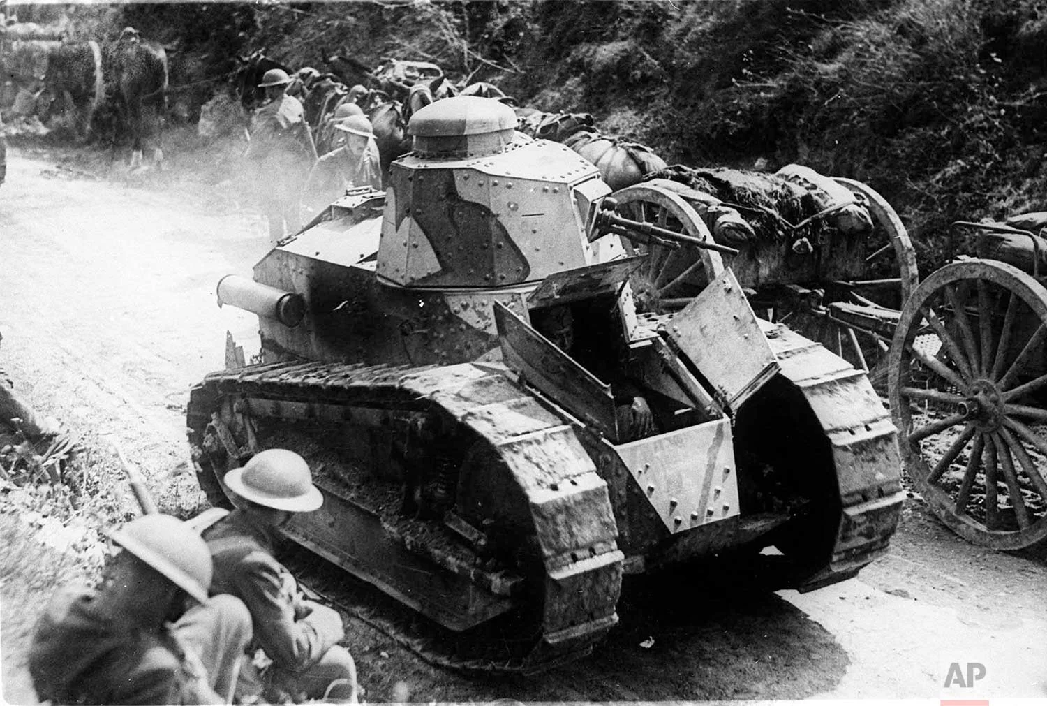 In this undated photo, two soldiers are passed by tanks on their way to support French troops in Juvigny, France, during World War One. (AP Photo)