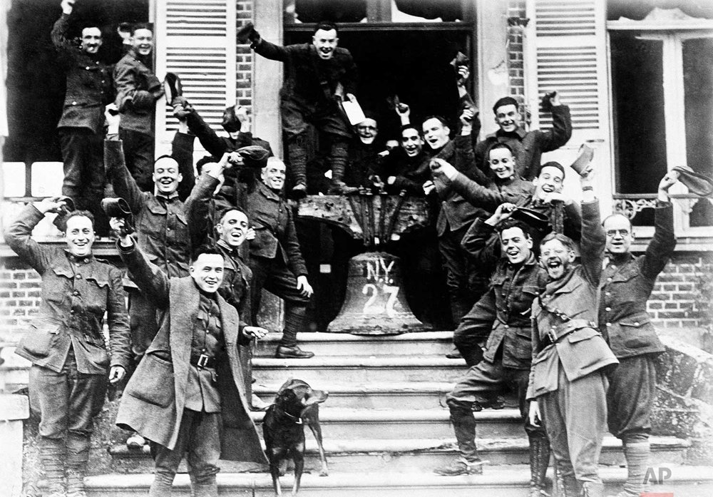  In this Nov. 1918 photo, American soldiers from New York, who served on the frontline in Cambria, France, rig up a Liberty Bell to celebrate the signing of the Armistice to end World War One. (AP Photo) 