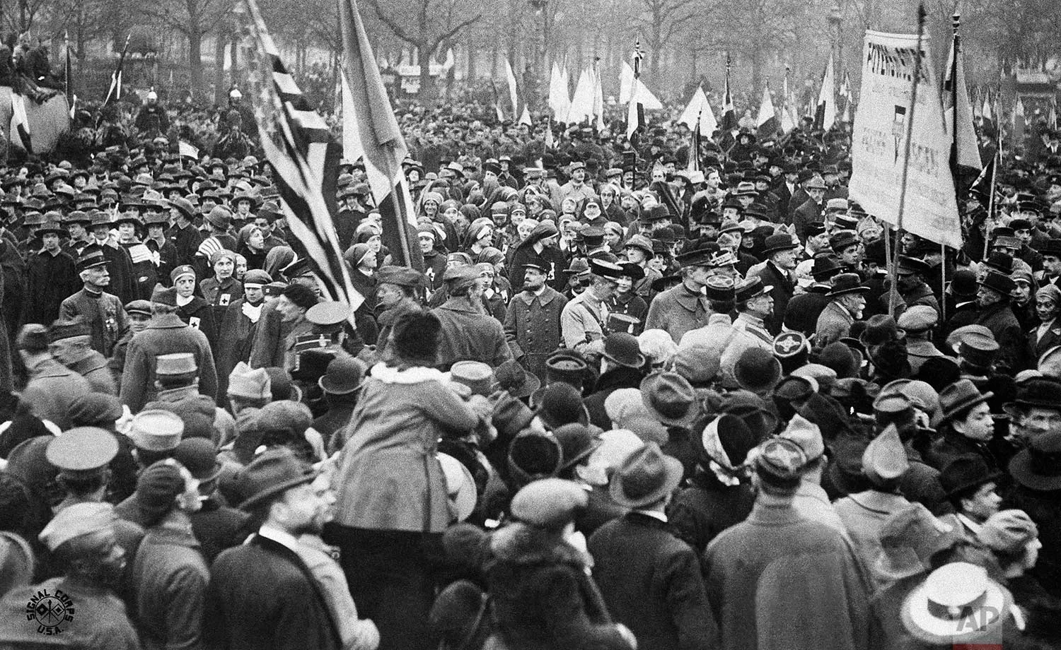 In this Nov. 11, 1918 photo, people in the streets of Paris, France, celebrate the signing of the Armistice that ended the fighting of World War One. (AP Photo)