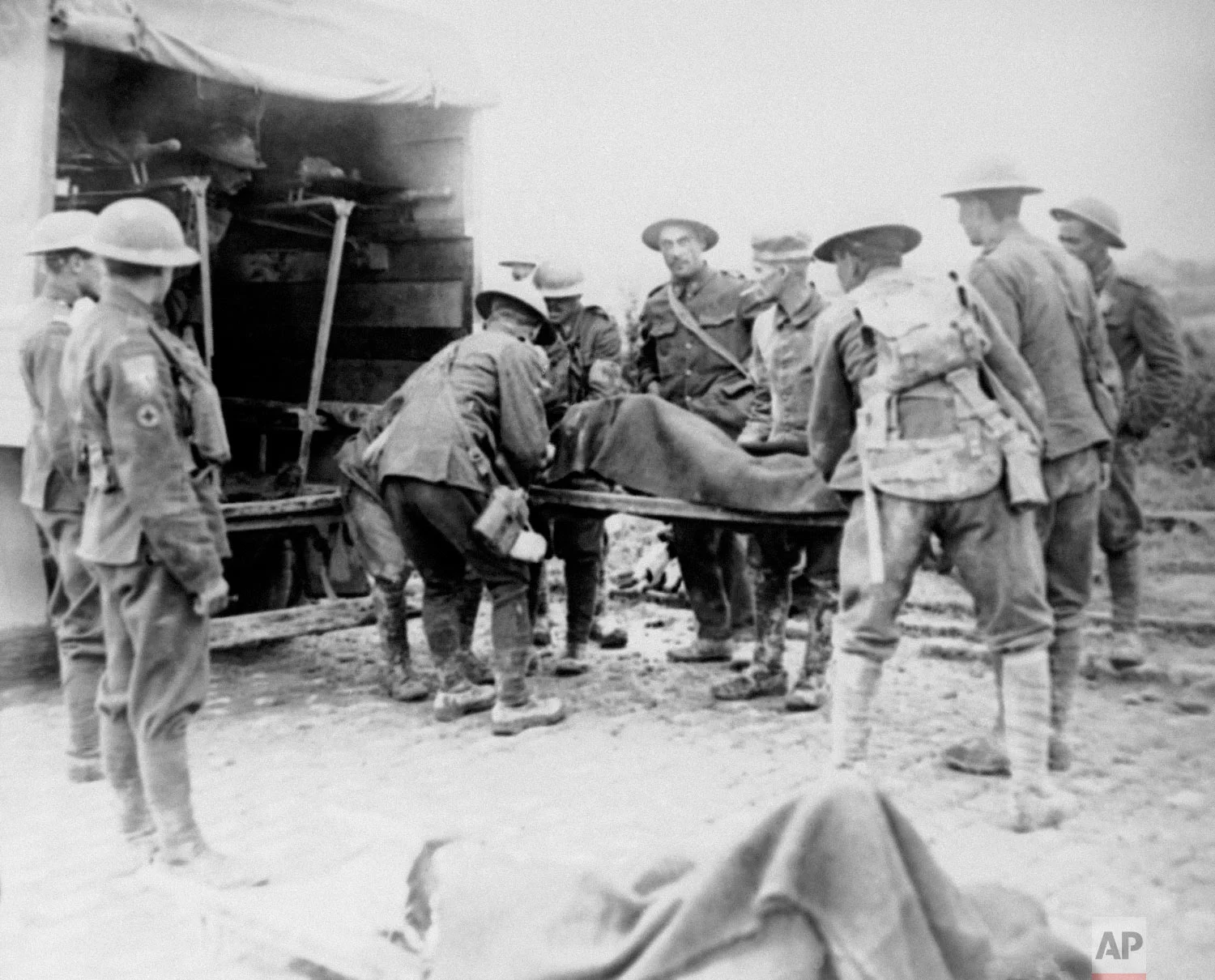 Wounded World War One soldiers are placed in ambulance during the advance on Lens, France. (AP Photo)