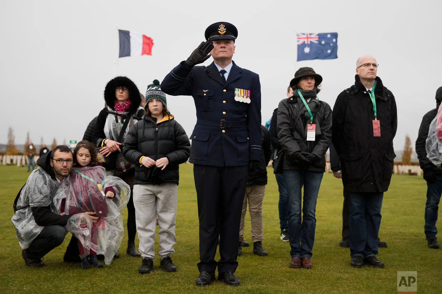 An Australian soldier listens along with visitors as French and Australian national anthems are played during an Armistice ceremony at the World War I Australian National Memorial in Villers-Bretonneux, France, Nov. 11, 2018. (AP Photo/Francisco Seco)